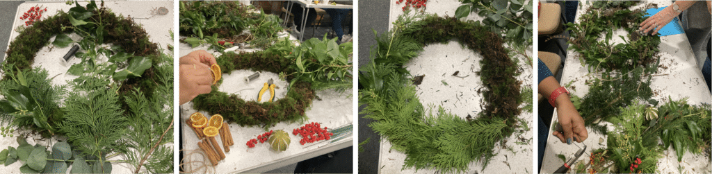 Wreaths in the process of being made. Surrounded by leaves, moss and other decorations. 